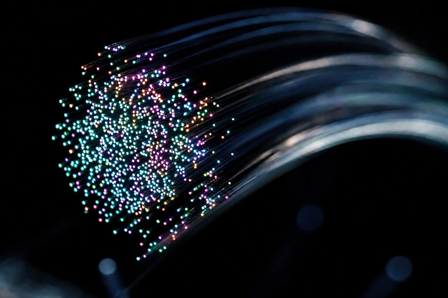 The glowing, many-coloured ends of a bundle of optical fibres